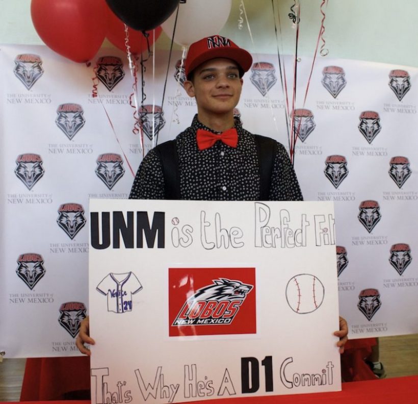 Nick Atkins holding a poster after signing with University of New Mexico.