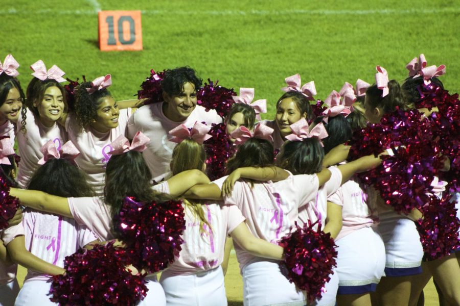 Cheer+team+in+Pink+Out+gear+at+the+varsity+football+game+against+Westchester.