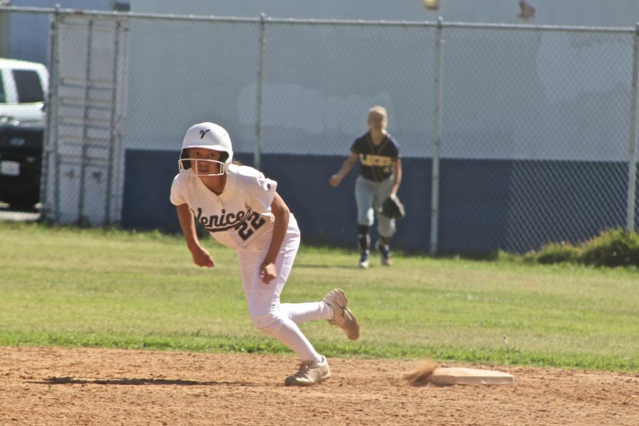 Cailee Grayhorse-Dupecki, number 22, running towards 3rd base