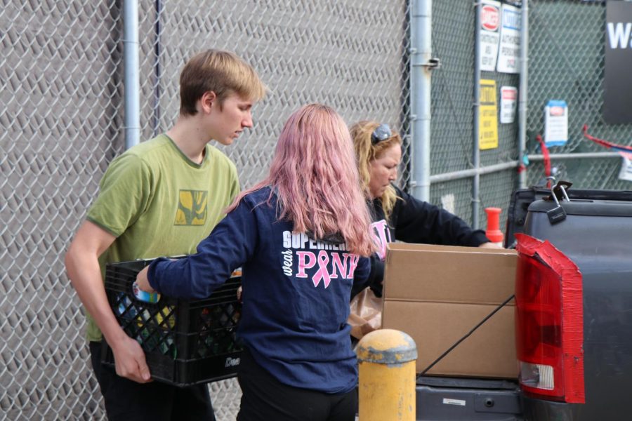 ASB helps load the donations gathered in their Food Drive onto a truck.
