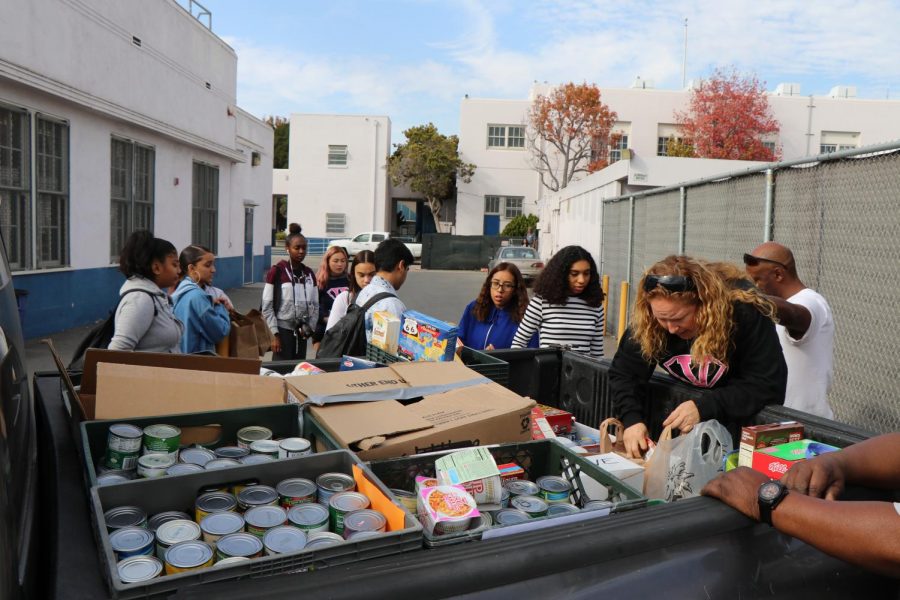 ASB helps load the donations gathered in their Food Drive onto a truck.