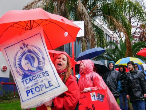 Rain or shine we walk the line! chant the crowd of teachers and students, as they march outside the picket line.