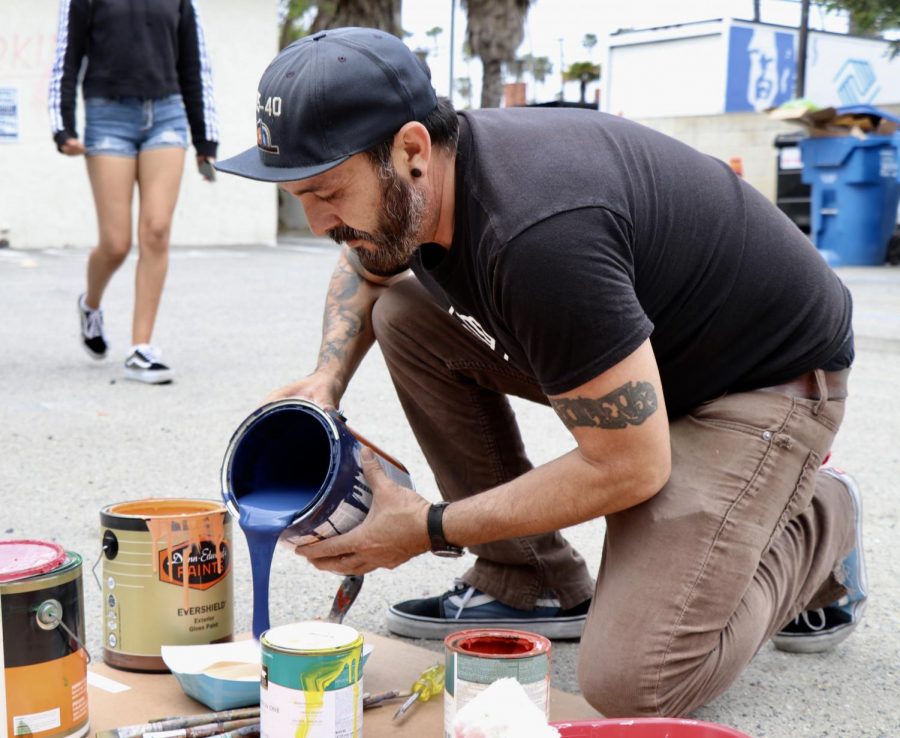BGCV staff member Lalo Marquez helps mix paints.
