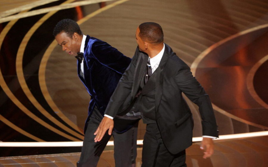 Will Smith hits at Chris Rock as Rock spoke on stage during the 94th Academy Awards in Hollywood, Los Angeles, California, U.S., March 27, 2022. REUTERS/Brian Snyder