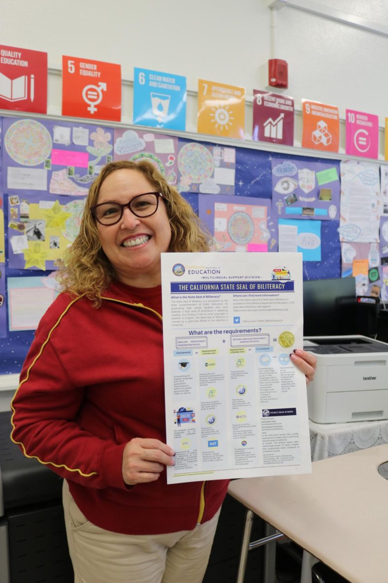 Ready for the test: Spanish teacher Angela Fajardo holds up the
requirements for Seals of Biliteracy.