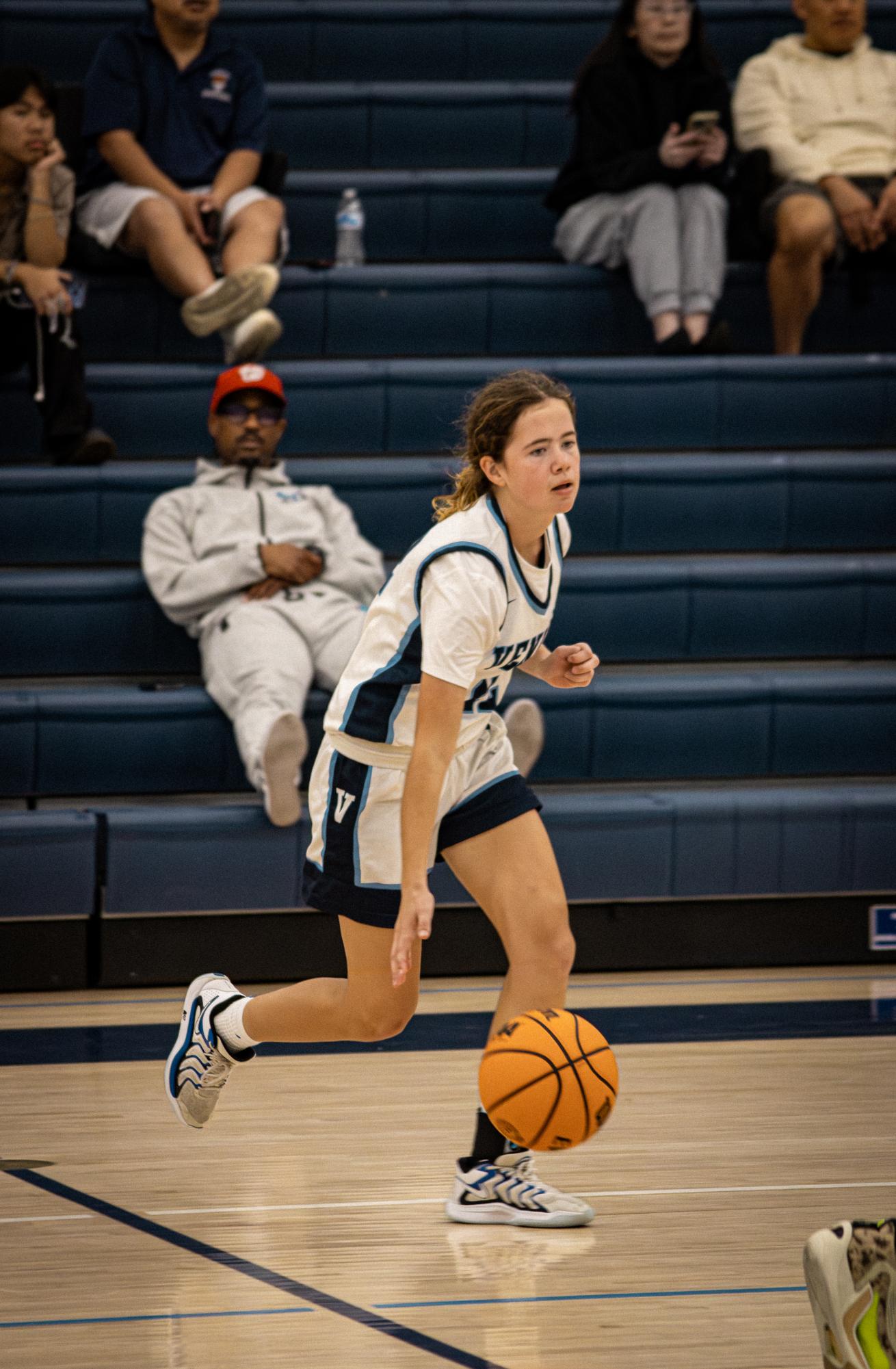 Assist: Senior Lily Vennewitz passes the ball during a home game against New Roads High School December 4.